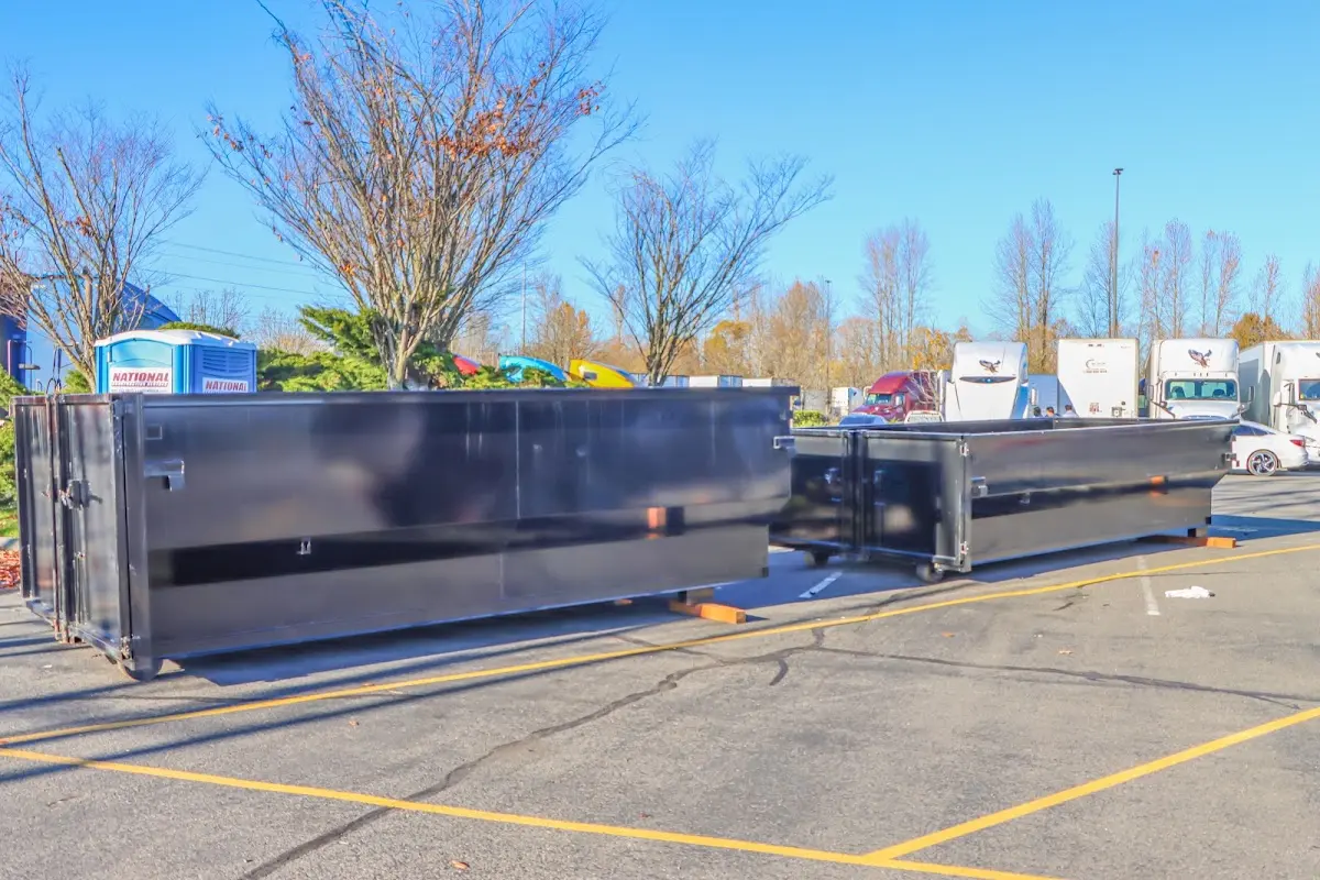 Professional dumpster rental service with roll-off container on residential driveway in Marlton